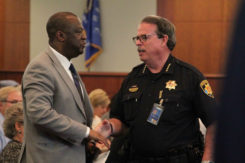 Douglas County School District Superintendent Thomas Tucker, left, and Sheriff Tony Spurlock shake hands at a special work session for the Douglas County Board of Commissioners on May 13.